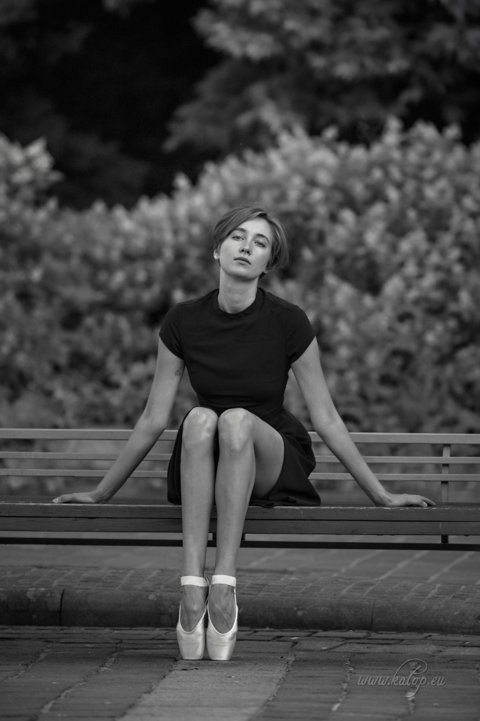 Ballerina, wooden bench and a stone ball